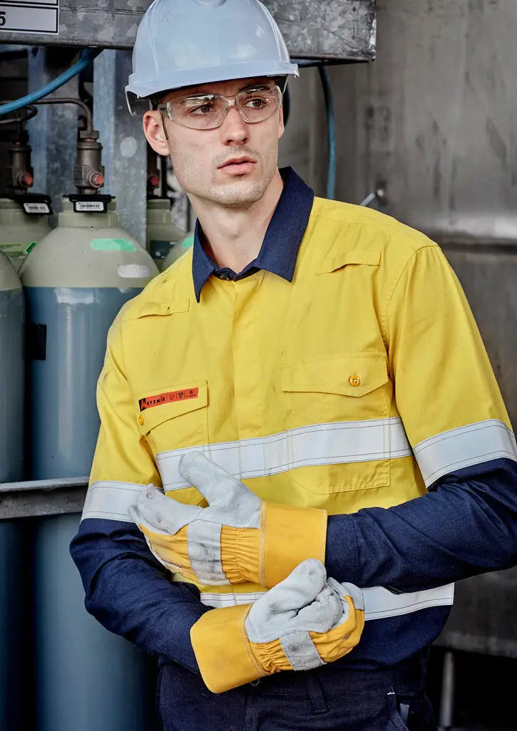Man in flamebuster garments and safety gear working in mining or electrical site