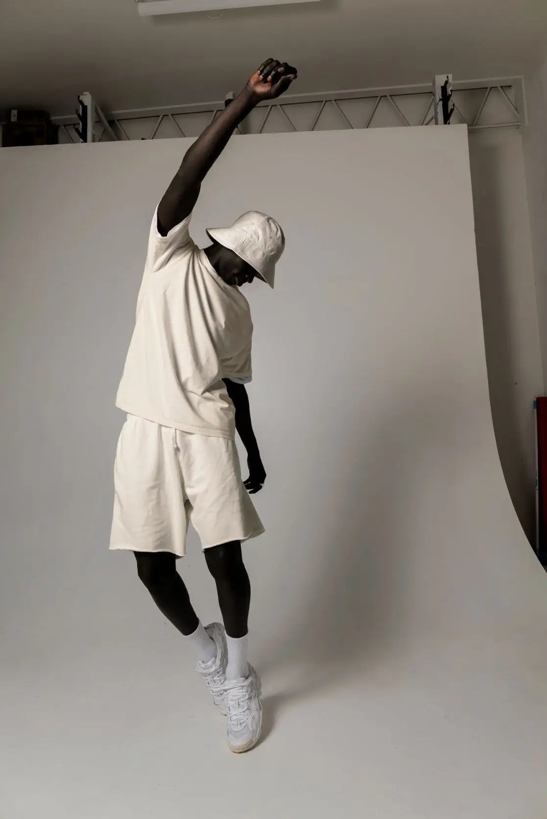 Man in off-white uniform super store outfit with sneakers, showcasing delivery charges info