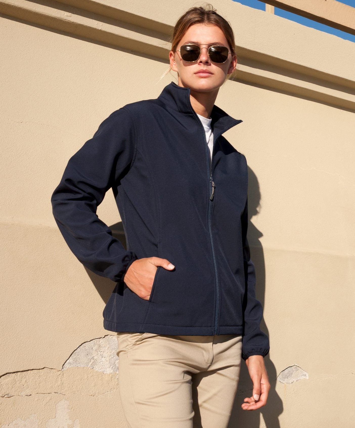 Navy blue softshell ladies alta jacket with full zipper and side pockets ideal for workwear and uniforms