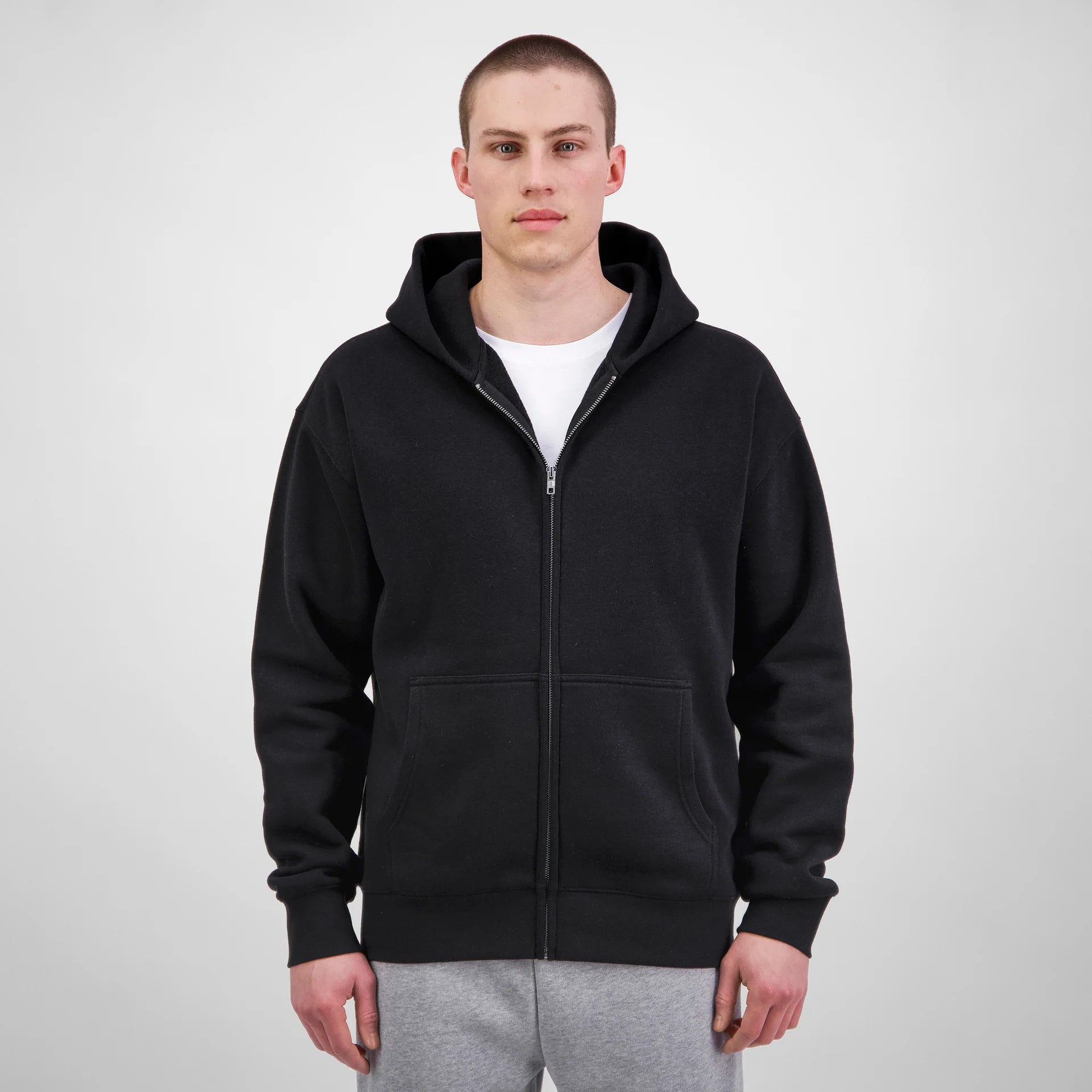 Person wearing a black hoodie on a white background