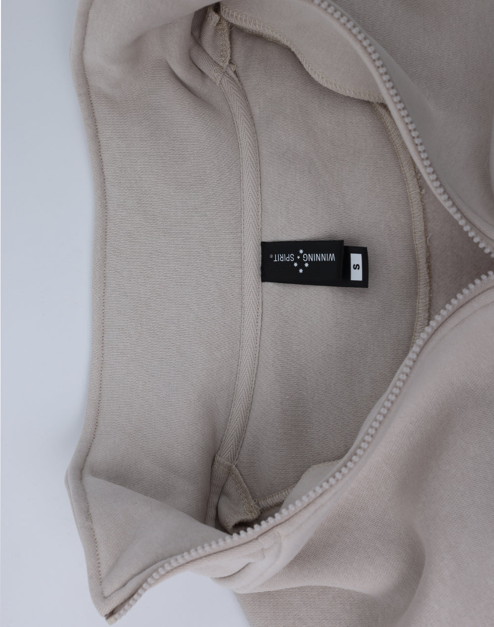 Beige half zip fleece jumper with soft textured fabric and black winning spirit tag perfect for workwear uniforms