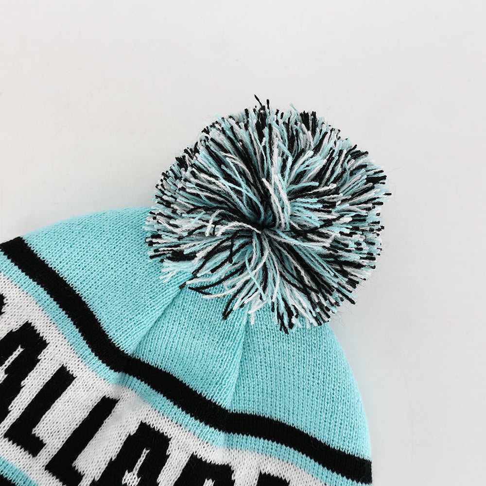 A light blue knitted pompom beanie with black white striped band and bold lettering perfect for work uniforms and workwear