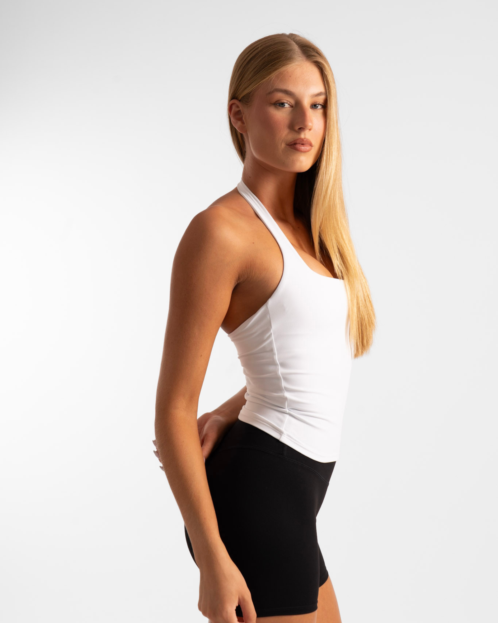 White arctic sculpt halter tank top with fitted silhouette and subtle seams perfect for workwear and uniforms