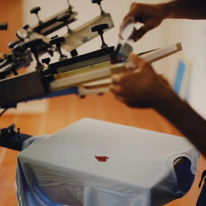 White red cardinal logo t-shirt in screen printing set up with dtf transfers