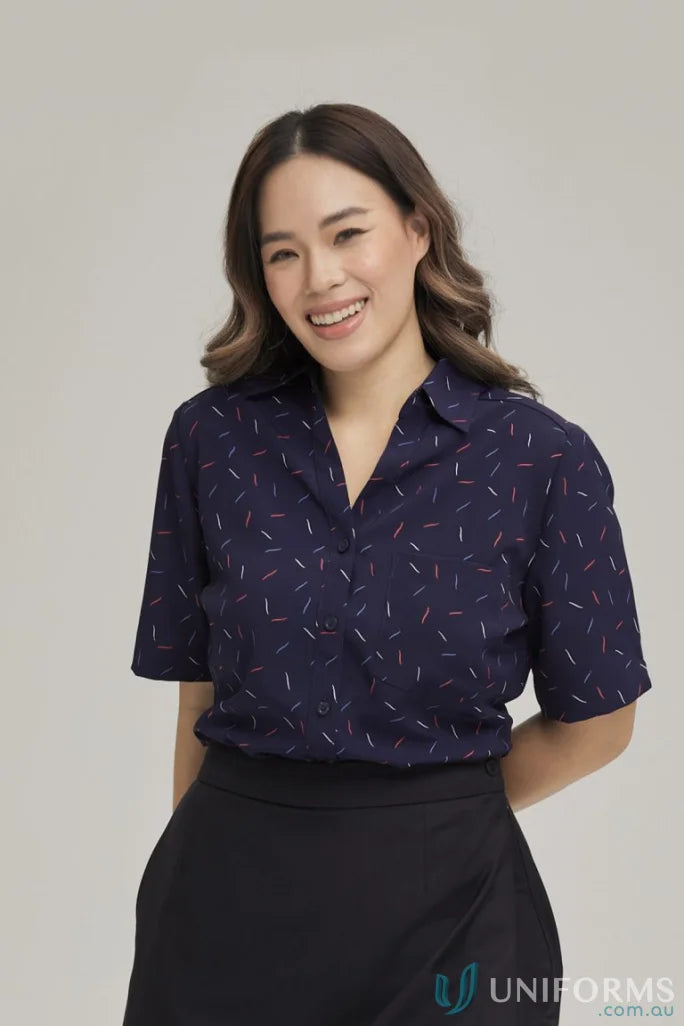 Woman in City Stretch Drift Print Tunic with dark blue dash pattern and black skirt