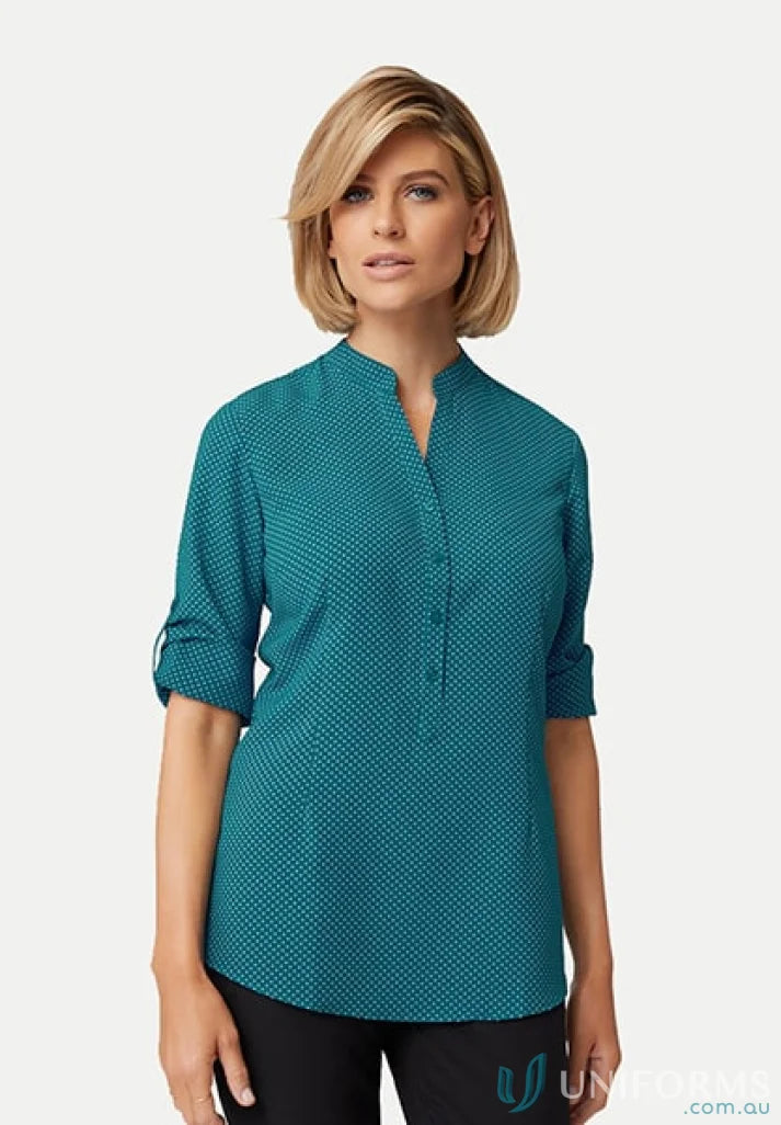 Woman in teal patterned blouse from City Stretch Spot Hi Low with roll-up feature and nehru collar