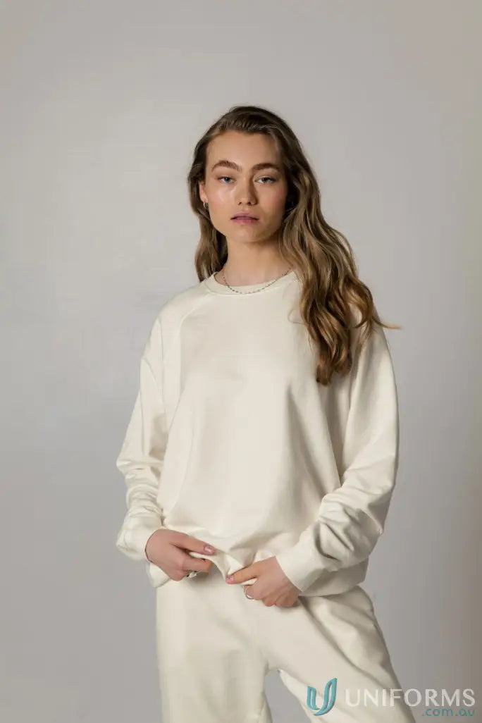 Woman in matching cream-colored Archie Crew Sweat in unbrushed French terry fabric