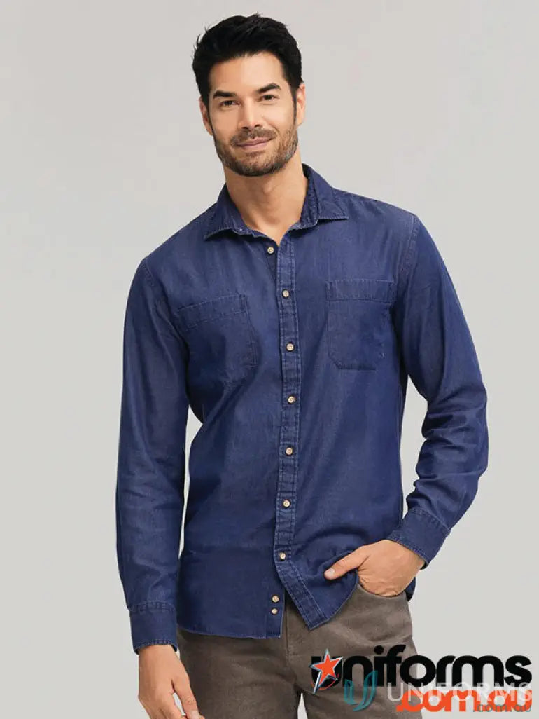 Man wearing a denim shirt with sports fit and garment washed look in brown pants