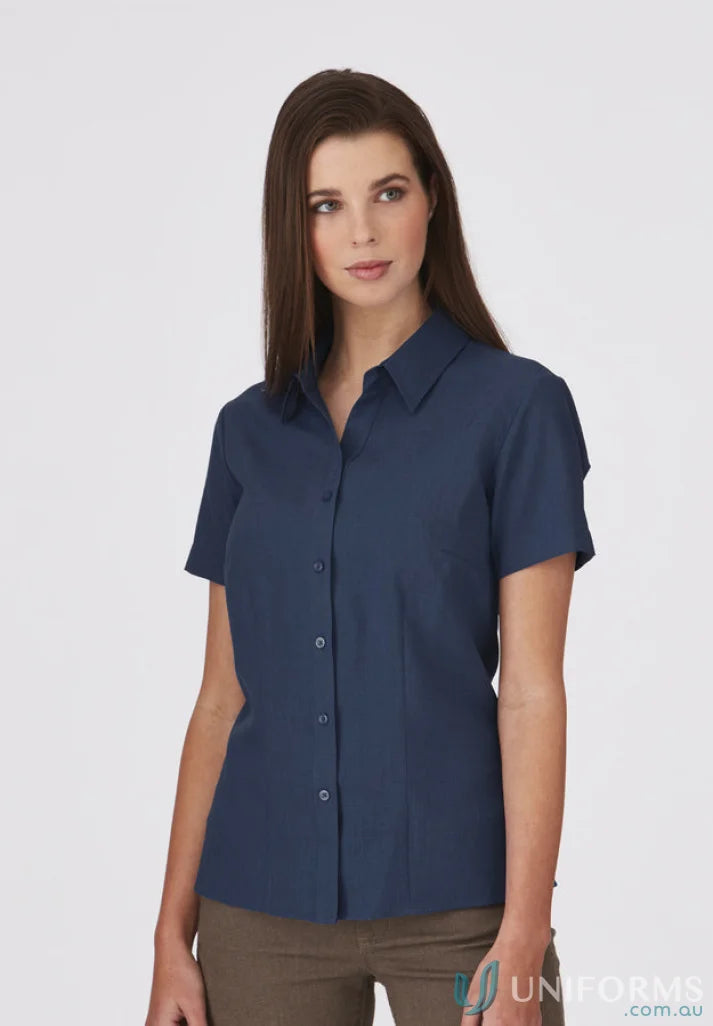 Woman wearing navy short-sleeved button-down shirt from Ezylin Ladies S/S Workwear Collection