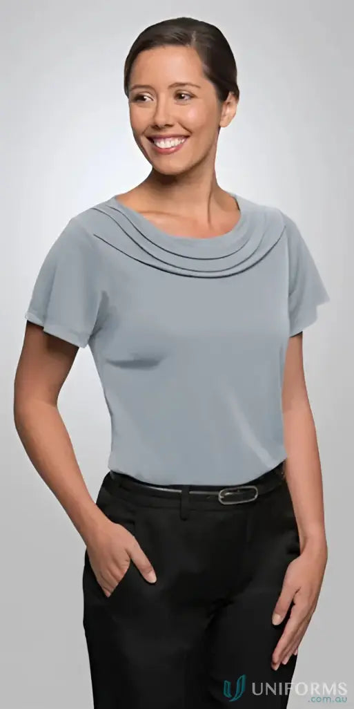 Eva knit style woman modeling light blue FMIG Ladies Knit SS Top with black trousers