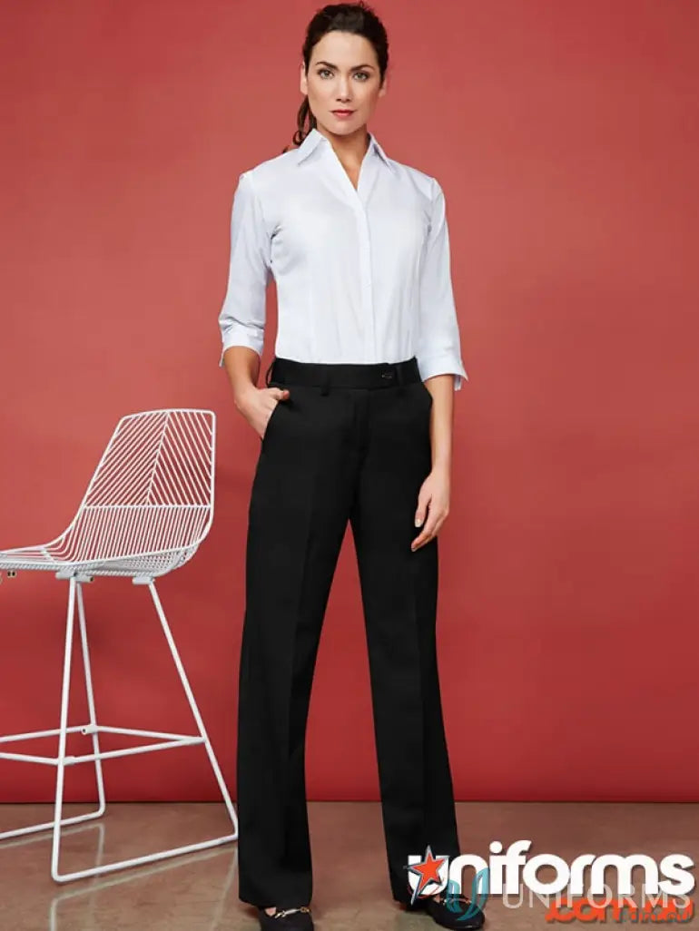 Woman wearing white shirt and black IOP Ladies Flexi Band Pant showcasing biz flexi-band™ style