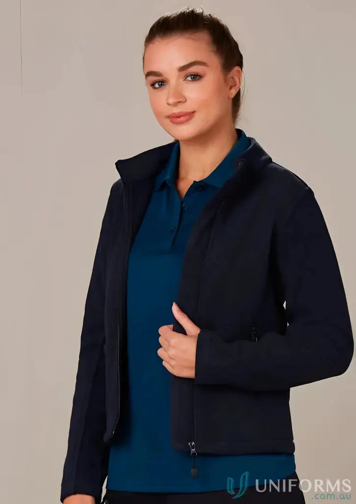 Woman in navy bonded polar fleece jacket and polo shirt showcasing Ladies Arjo Fleece Jacket