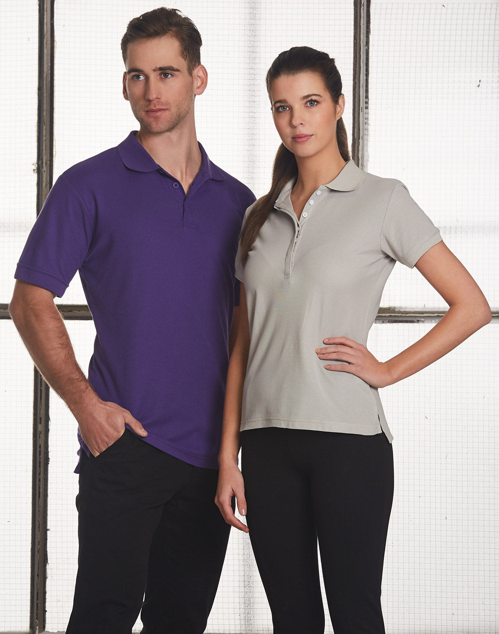 Ladies TrueDry Connection polo: man and woman in purple and gray shirts