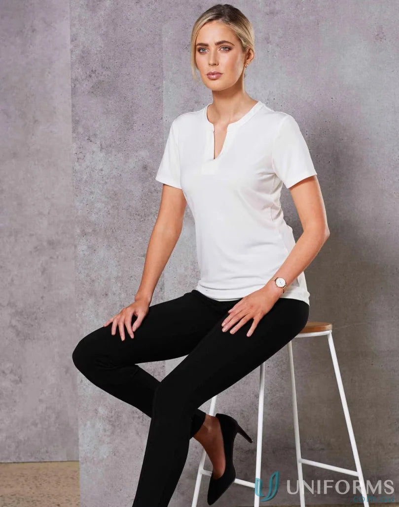 Lady wearing Sofia Ladies Knit Top with inset V-neck tab and black pants
