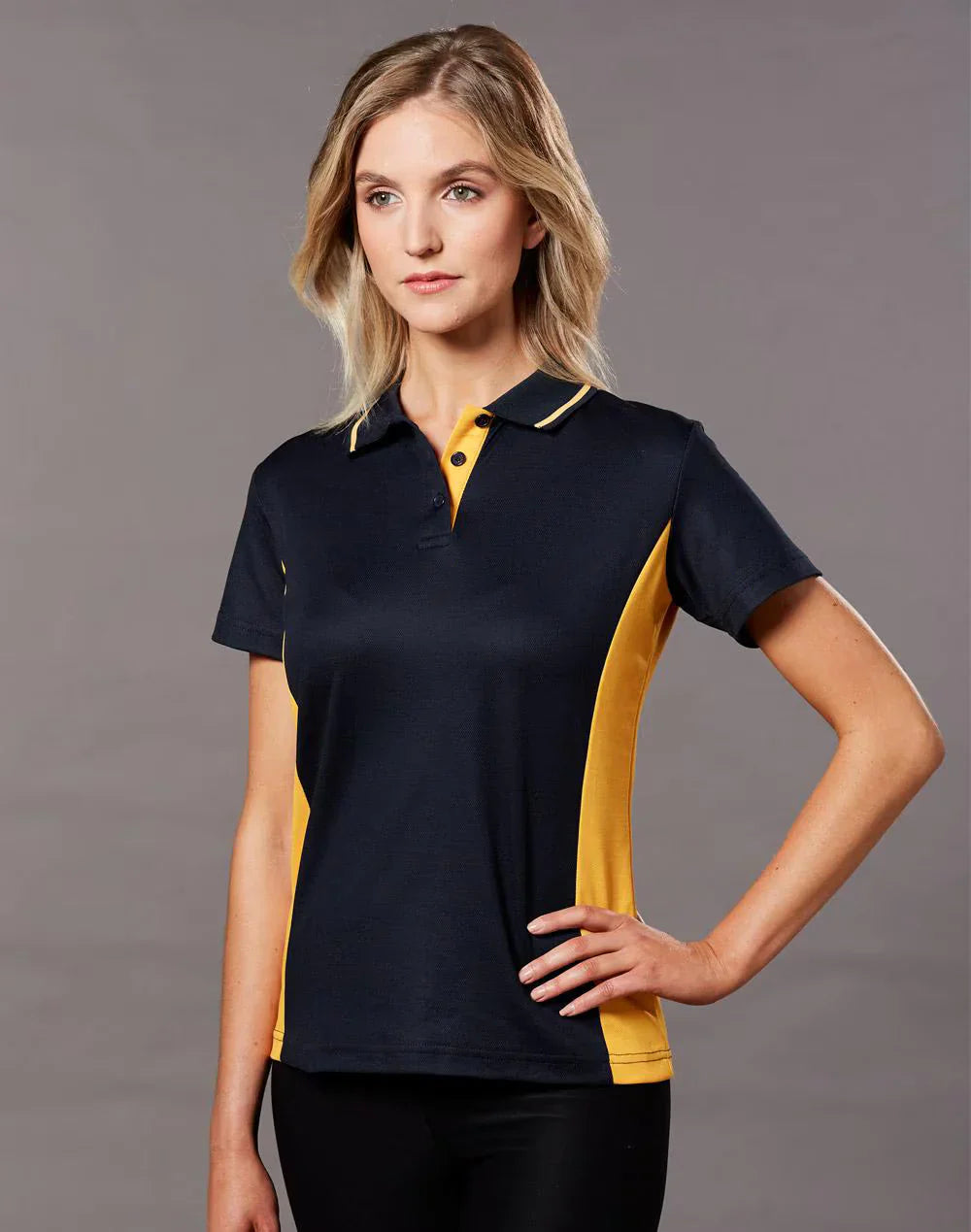 Ladies teammate polo in navy blue and yellow with moisture-wicking fabric