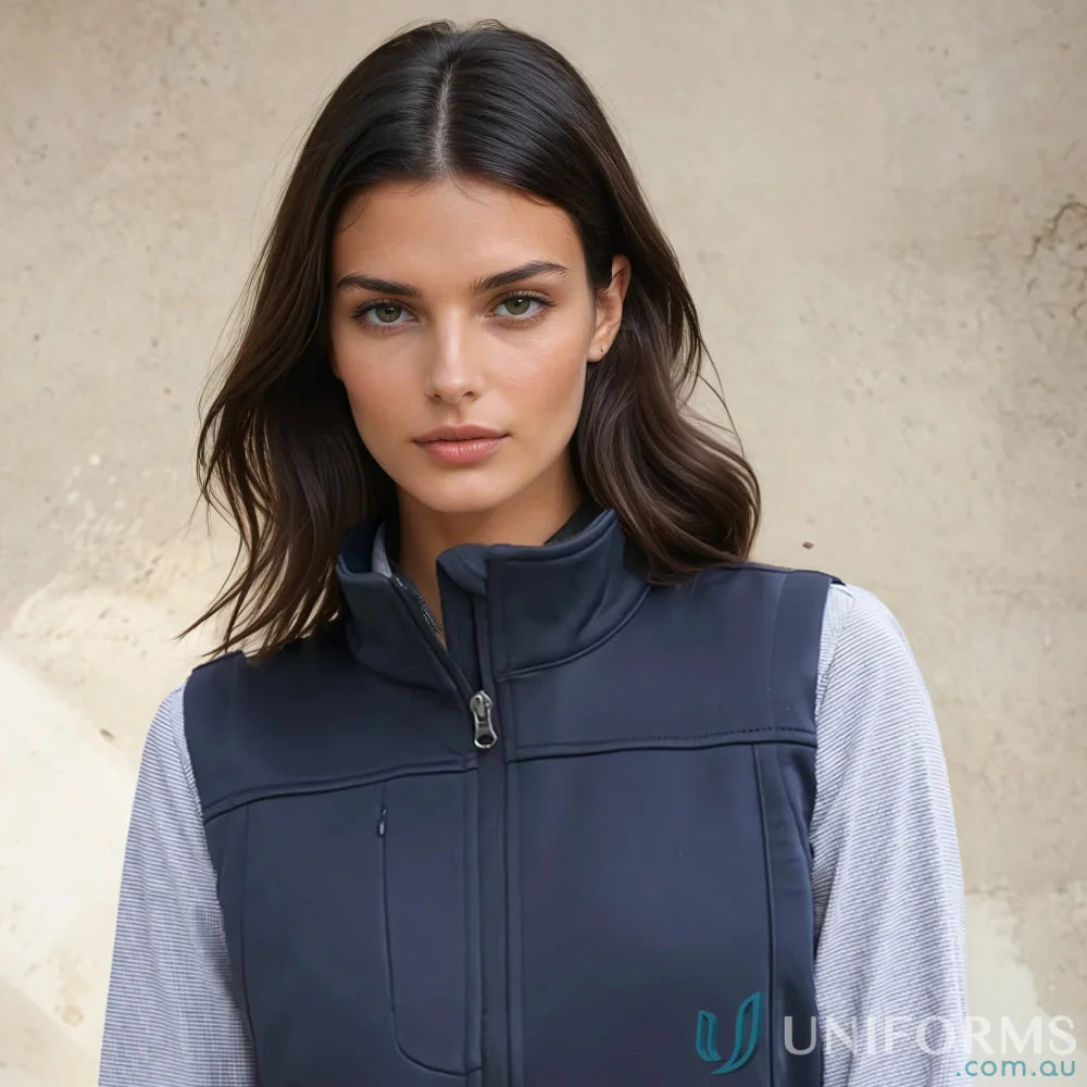 Woman wearing dark blue Ladies U:Tech SoftShell Vest from Biz Collection Womens softshell vest j29123