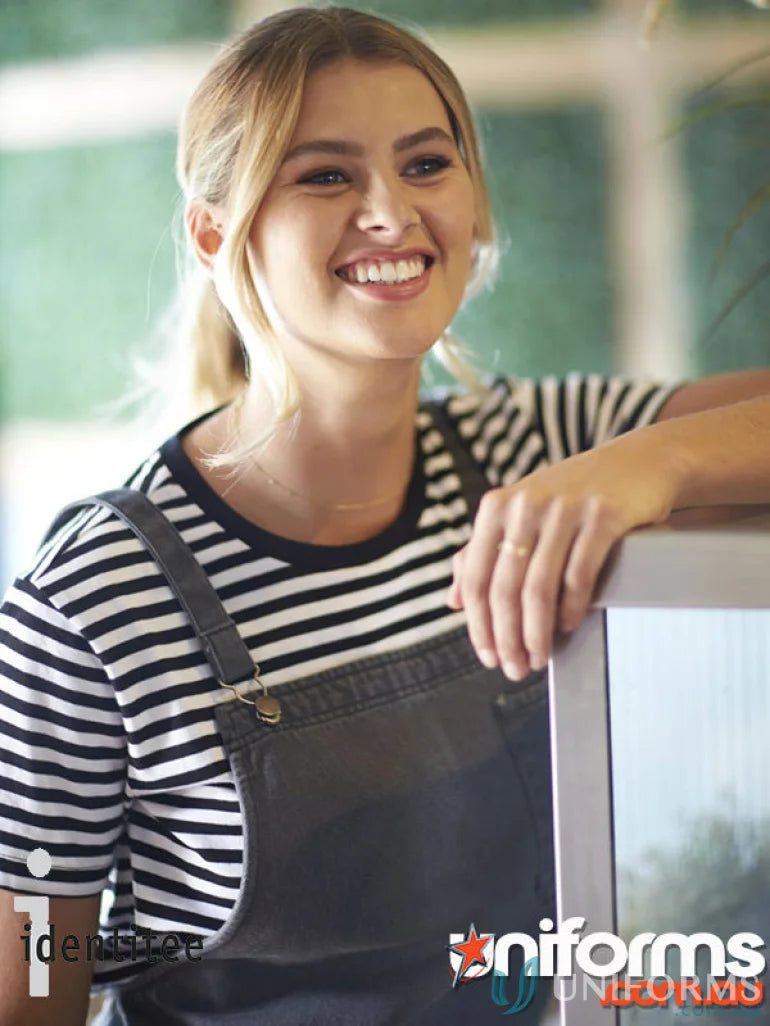 Smiling woman in Louie Stonewash Apron with reinforced metal rivets and metal dungaree clip