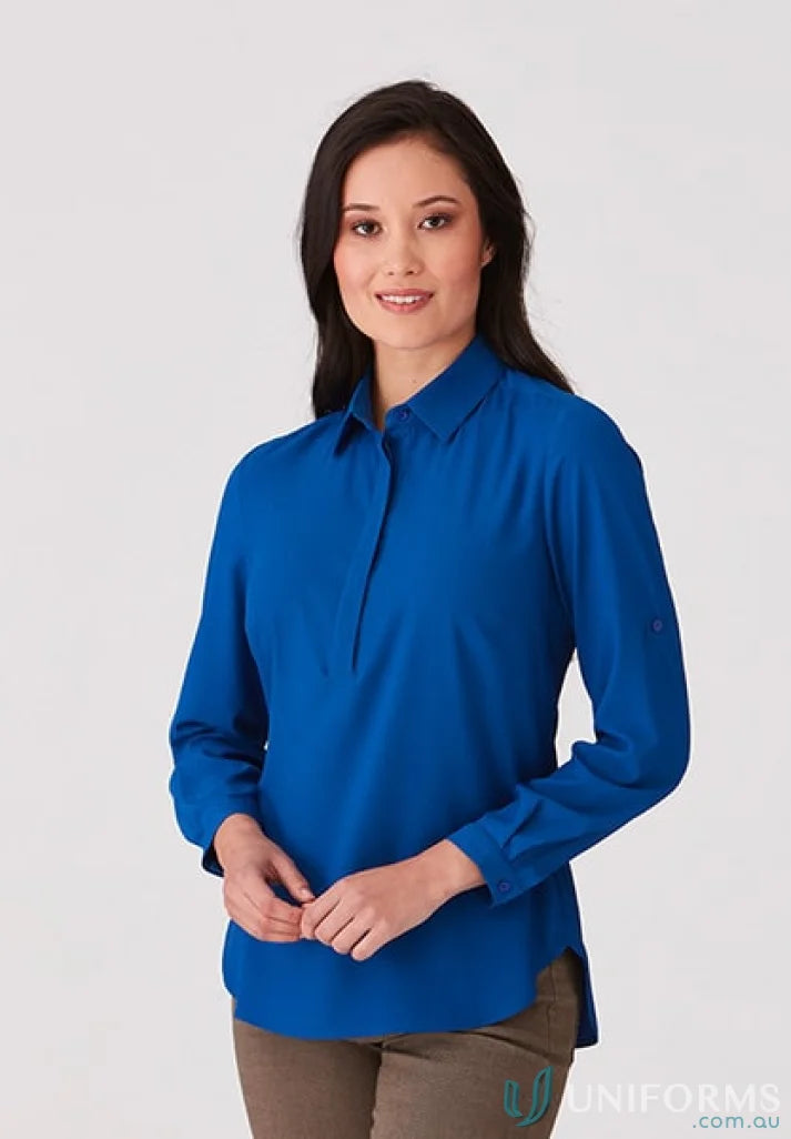 Woman wearing Meghan Top in blue action fit long-sleeve medical uniform shirt