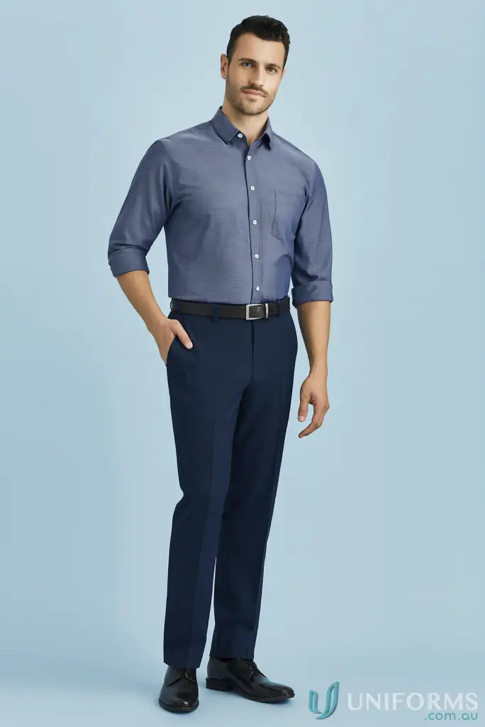 Man modeling blue button-down shirt and tapered workwear pants for work uniforms