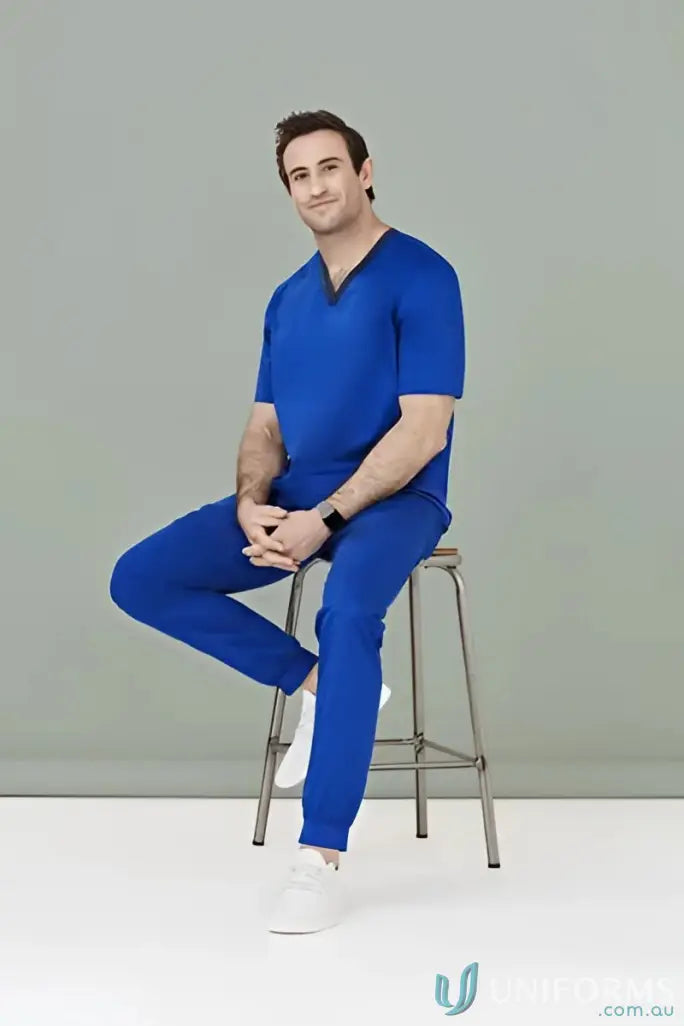 Man wearing blue Riley Slim Leg Jogger Scrub Pant for a comfy slim leg jogger look