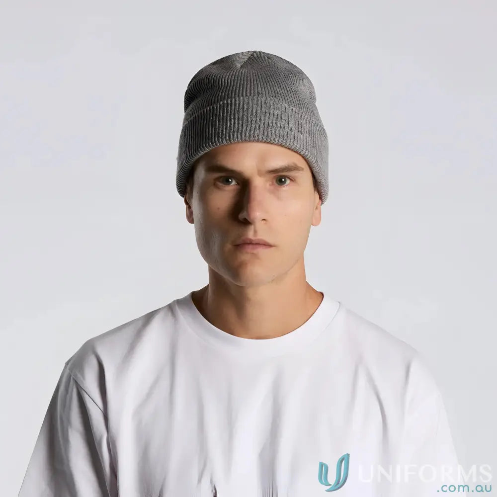 Man wearing a grey knit beanie with cuffed hem and longer body style