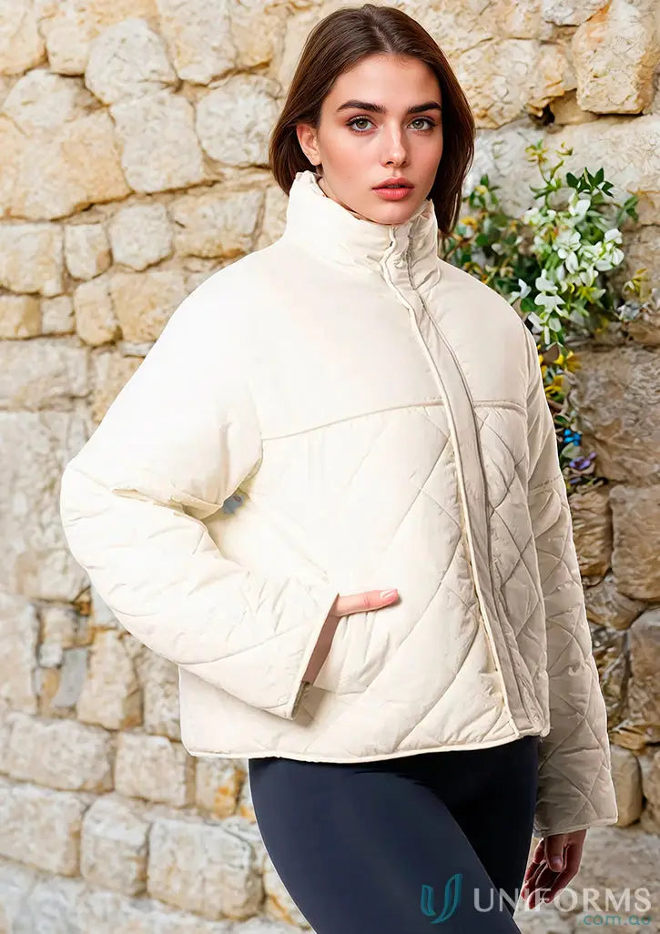 Cream-colored quilted puffer jacket with high stand-up collar and internal zip pocket