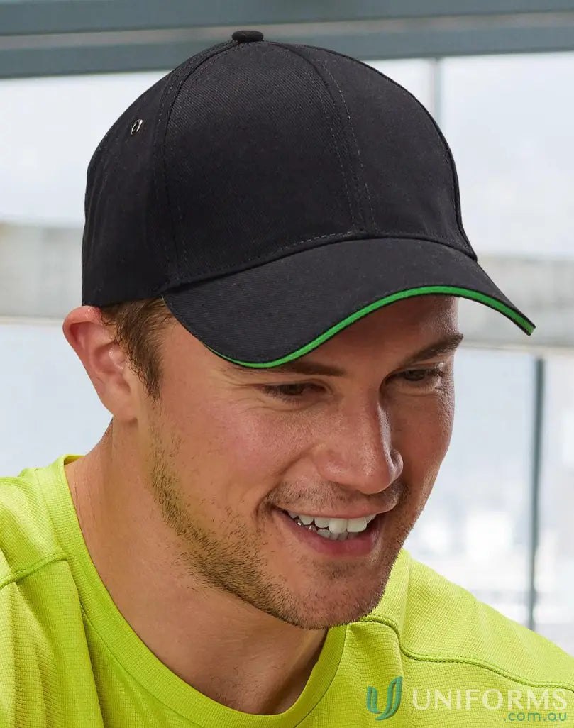 Winning Spirit Sandwich Peak Cap with black and green design and tuck-in fabric strap