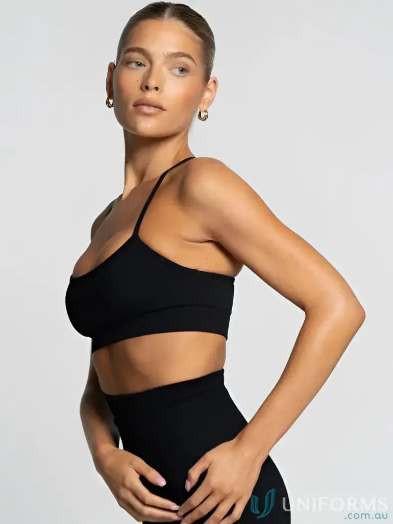 Black seamless onyx active crop sports bra with thin straps and high-waisted leggings ideal for workwear uniforms