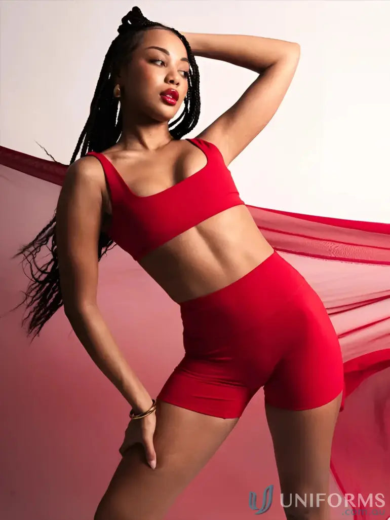 Red two-piece athletic set with square neck cherry crop top and high-waisted shorts made from stretchy material ideal for work uniforms