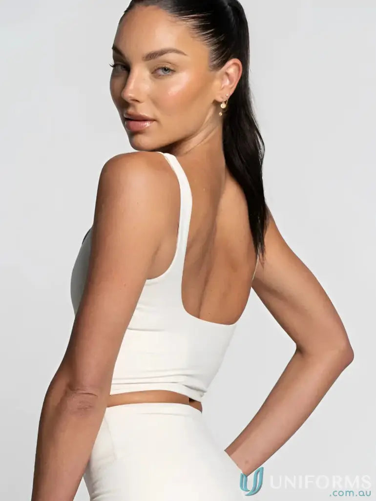 White cropped sports bra with thin straps and backless design perfect for workwear and uniforms layers