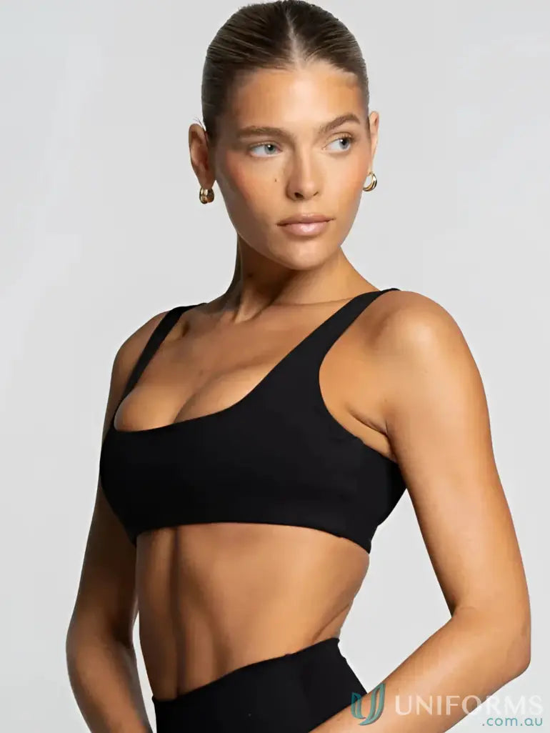 Black one-shoulder sports bra with thin straps and sleek design perfect for workwear and active uniforms