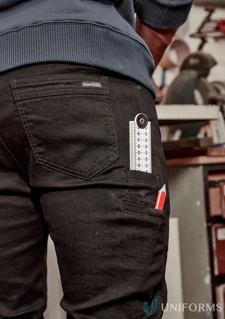Black work pants with tools showing streetworx stretch jean for demand performance in men