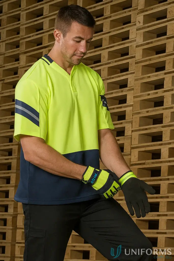 Man wearing Syzmik Mens Astro Short Sleeve Polo with reflective stripes and work gloves