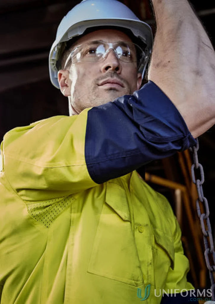 Construction worker in safety gear wearing Syzmik Mens Rugged Cooling Vis Shirt ZW128 focusing on stress points