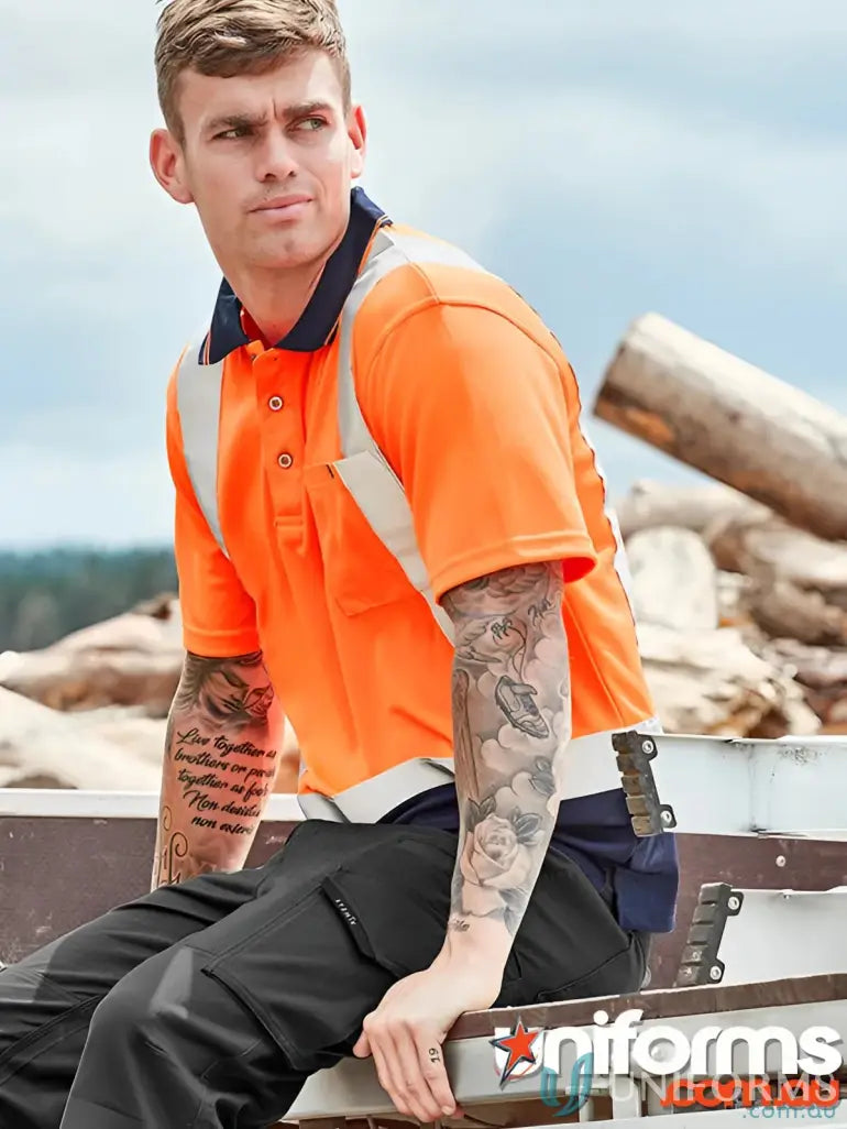 Man in orange vis spliced short sleeve polo with reflective shoulder tape and black work pants
