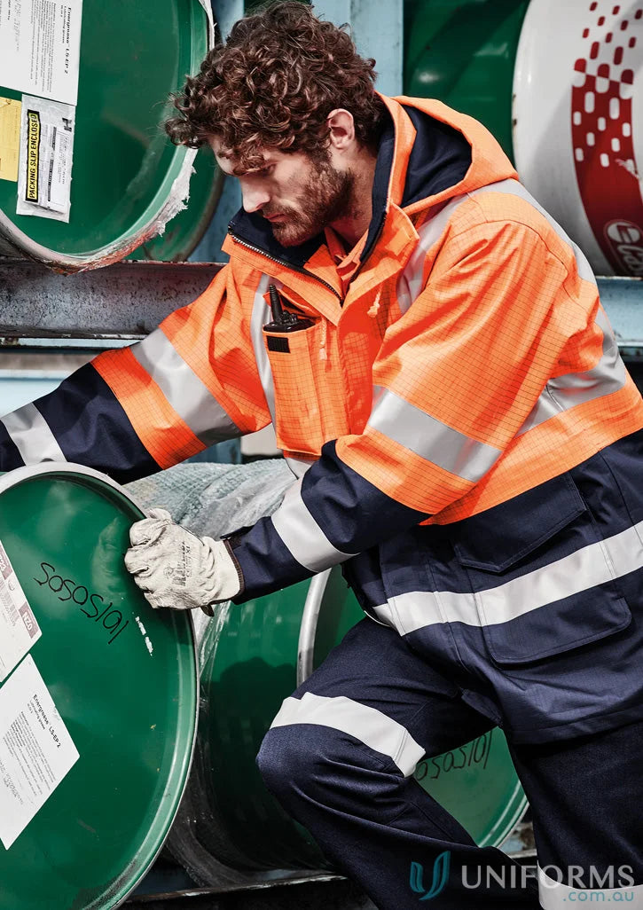 Man wearing Syzmik ZJ900 waterproof jacket, mens orange flame arc rated antistatic gear