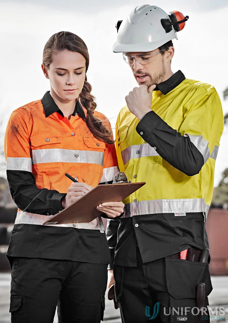 Two construction workers in safety gear wearing Syzmik Mens Industrial Long Sleeve Shirt hoop taped zw123 for demanding work environments
