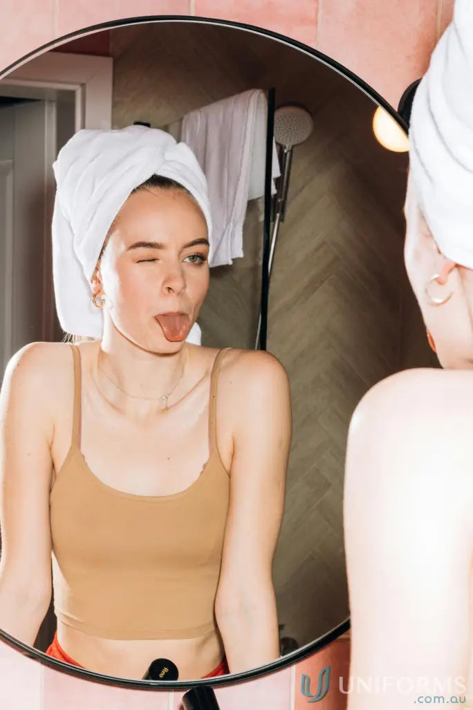 Woman winking in mirror with Terry Velour Beach Towel perfect for velour beach days