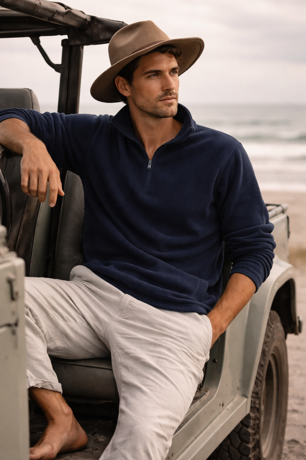 Man in Biz Collection Trinity half zip with concealed pockets, navy fleece, beige pants