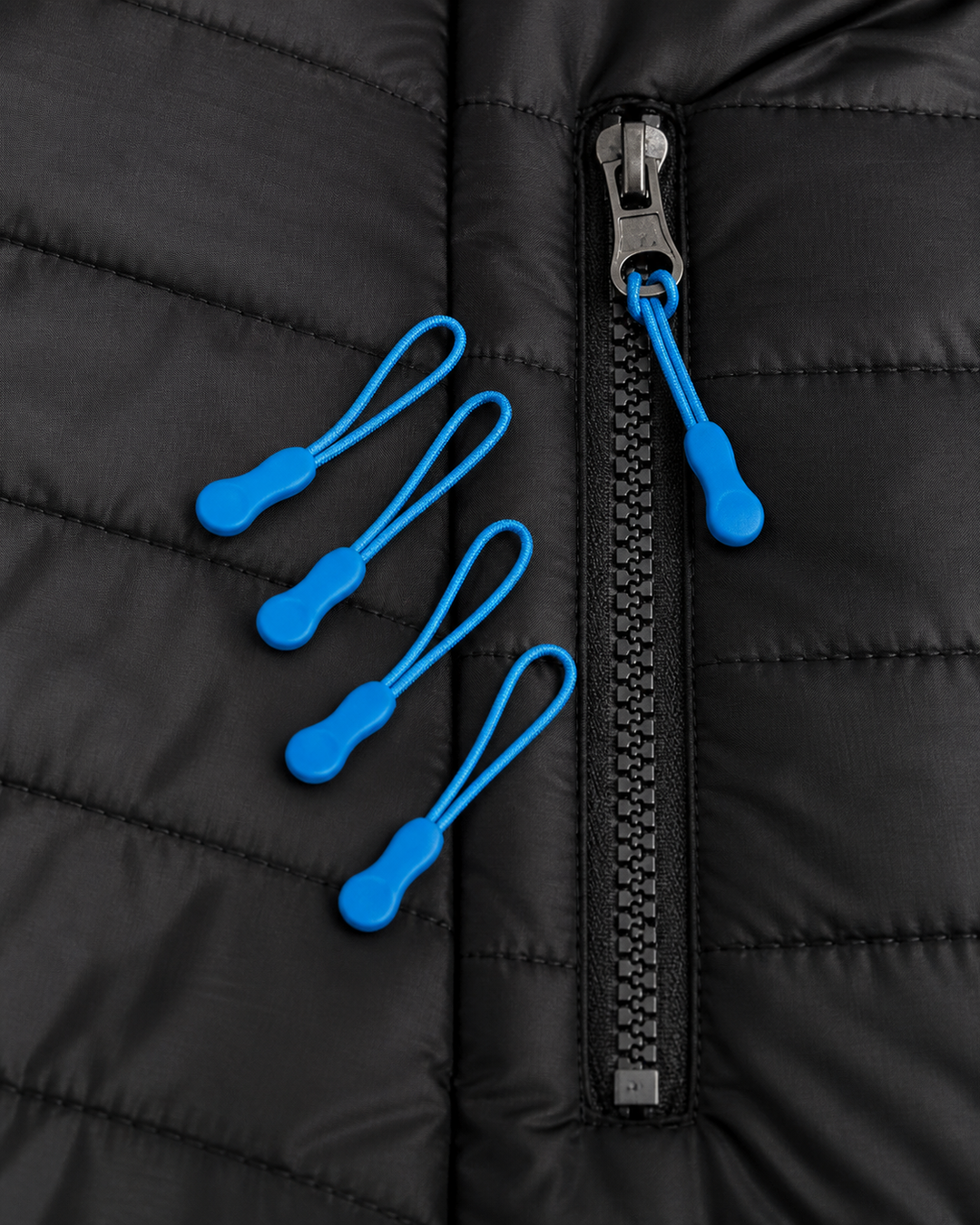 Cyan Zippies zipper pull accessories on black quilted jacket