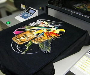 Black t-shirt with colorful graphic print showcasing DTG printing prices in action