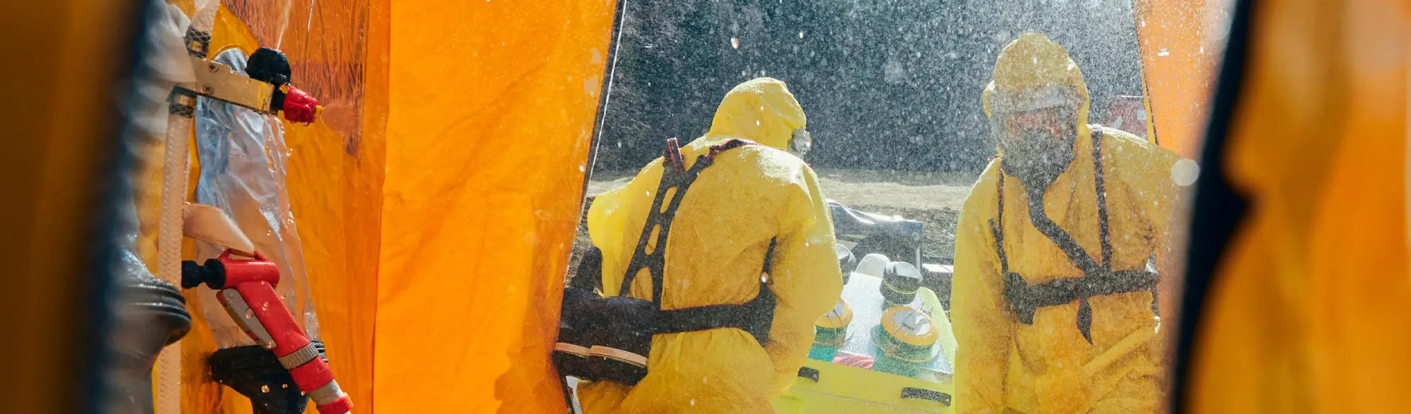 Hazmat-suited personnel near PPE Fixed Emergency Showers and eye wash stationsSafety solutions
