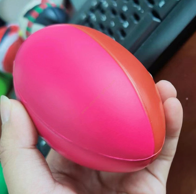 A vibrant pink and orange silicone custom aussie rules stress ball perfect for workwear and uniforms stress relief