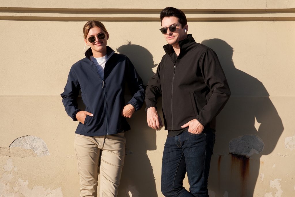 Navy blue ladies alta softshell jacket with high collar zip front and two pockets perfect for work uniforms and workwear