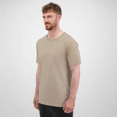 Man wearing a beige t-shirt against a white background