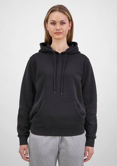 Person wearing a black hoodie and gray pants on a white background