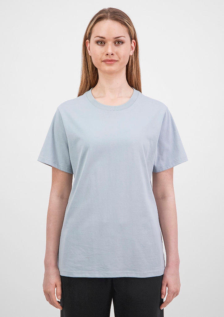 Woman wearing a light gray t-shirt against a white background