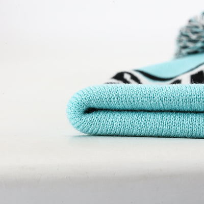 Light blue knitted pompom beanie with textured pattern perfect for workwear uniforms and casual work uniforms