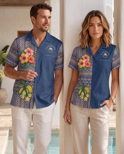 A man and a woman modeling matching blue short-sleeve camp shirts with floral and geometric patterns, standing in a sunlit outdoor setting near a pool.