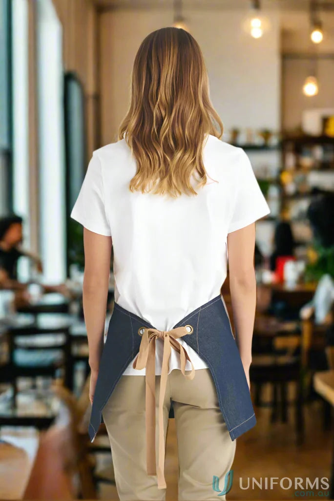 Woman wearing a Bronte Original Denim Apron in indigo denim for a stylish look